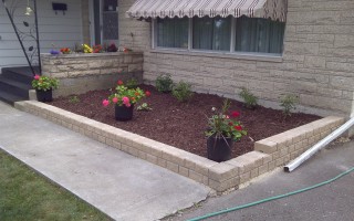 Yard after renovation with new stack stone and plantings