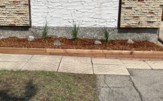 Clean flower bed with new stack stone and red mulch