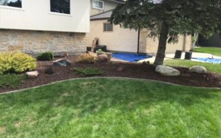 Refreshed flower bed with new red enviro mulch